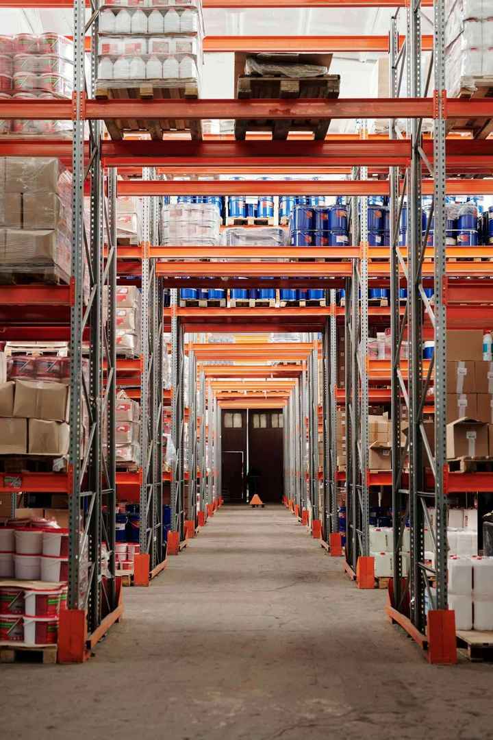 Organized warehouse shelves representing repeatable revenue systems and operational capacity